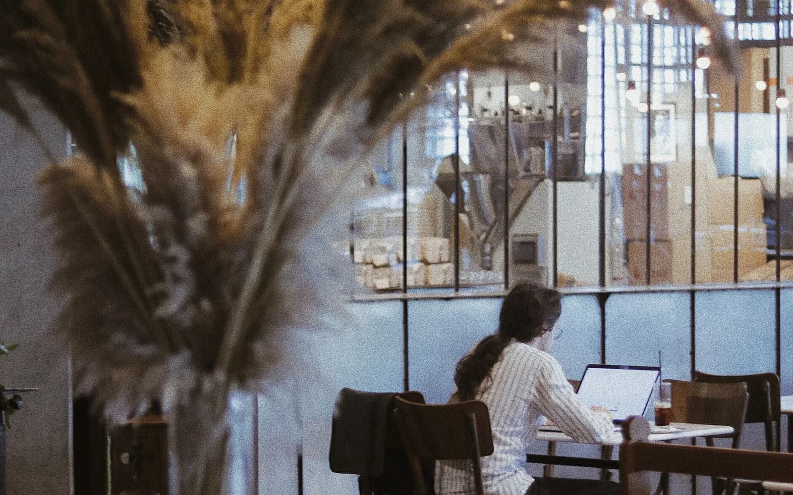 Editorial photograph: Unrecognizable student with laptop studying in library