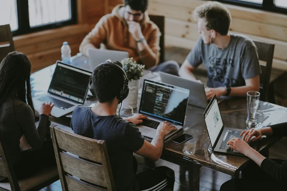 Real team working together around laptops