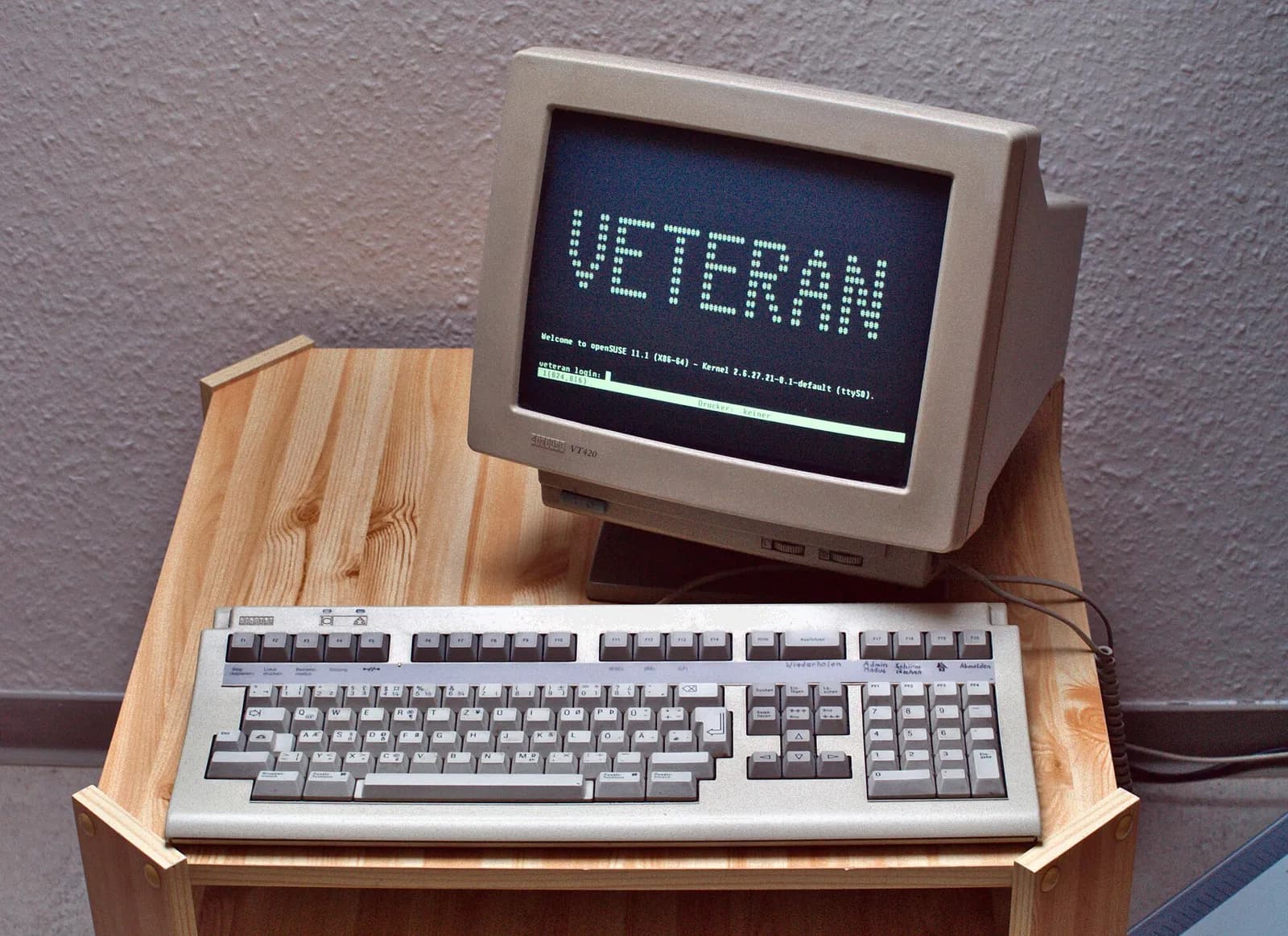 An old text terminal with a keyboard, showing a command-line login screen